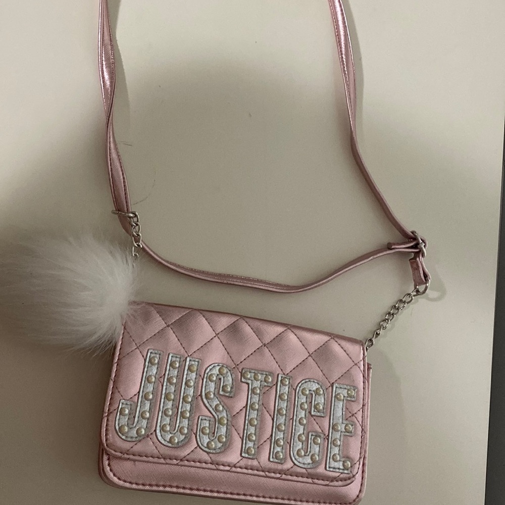A small kids pink and silver justice bag
